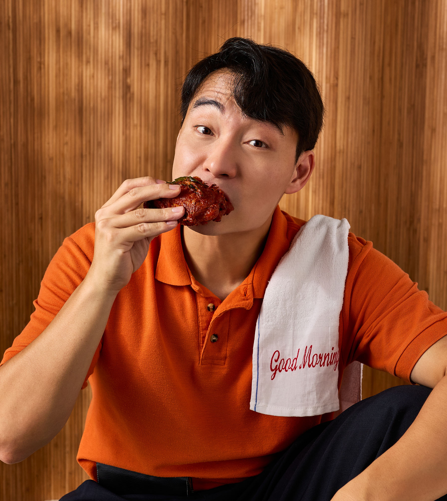 Nigel Ng tucking into a chicken drumstick